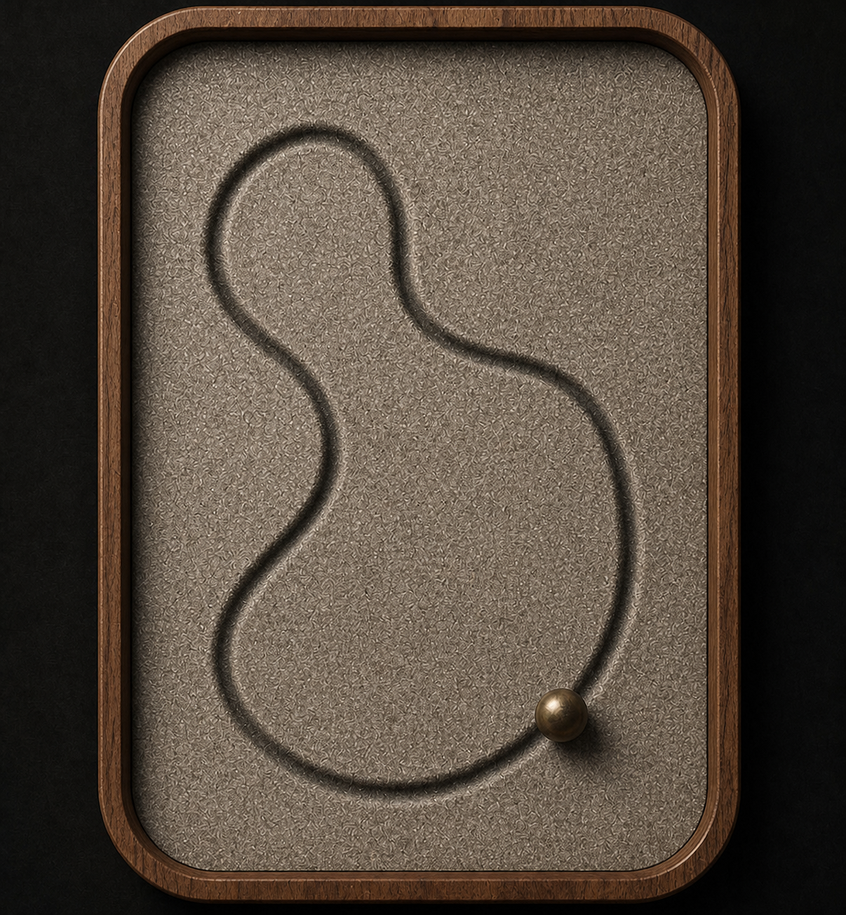 A smoked-walnut tray filled with fine mineral sand, showing a curved path and one brass bead.